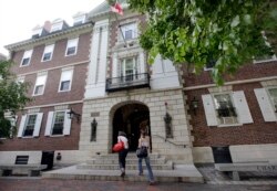 FILE - Students walk into Kirkland House on the campus of Harvard University in Cambridge, Mass.