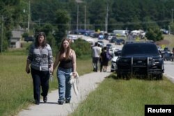 People walk near the scene of a shooting at Apalachee High School in Winder, Georgia, Sept. 4, 2024.