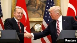 Presiden Turki Recep Tayyip Erdogan (kiri) berjabat tangan dengan Presiden AS Donald Trump pada konferensi pers bersama di Gedung Putih, Selasa (16/5).