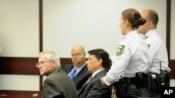 Oscar Ray Bolin Jr., far left, sits with handcuffs on after being found guilty in the killing of Natalie Blanche Holley, April 19, 2012.