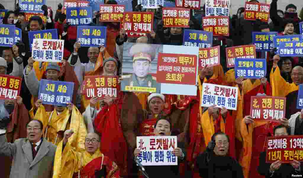 South Korean Buddhist monks shout during a protest blaming North Korea's rocket launch in central Seoul December 12, 2012. North Korea successfully launched a rocket on Wednesday, boosting the credentials of its new leader and stepping up the threat the i