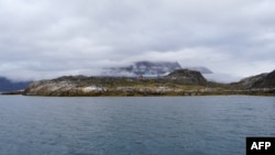 Rumah akomodasi bagi para turis terlihat berada di atas bukit di dekat Maniitsoq, di pesisir barat Greenland, pada 3 September 2024. (Foto: AFP/James Brooks)