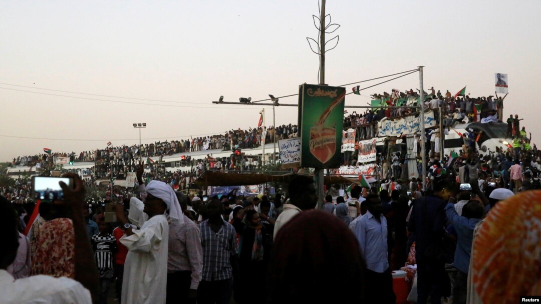 Sudanese demonstrators ride atop a train from Atbara, birthplace of an uprising that toppled former President Omar al-Bashir, as they approach military headquarters in Khartoum, Sudan, April 23, 2019.