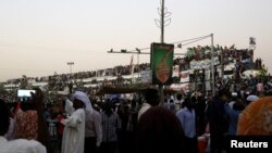 Sudanese demonstrators ride atop a train from Atbara, birthplace of an uprising that toppled former President Omar al-Bashir, as they approach military headquarters in Khartoum, Sudan, April 23, 2019.