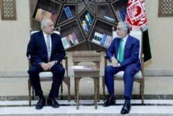 FILE - U.S. special representative for Afghanistan, Zalmay Khalilzad (L), meets with Afghanistan Chief Executive Abdullah Abdullah in Kabul, Afghanistan, Sept. 2, 2019. (Afghan Chief Executive office/Handout via Reuters)