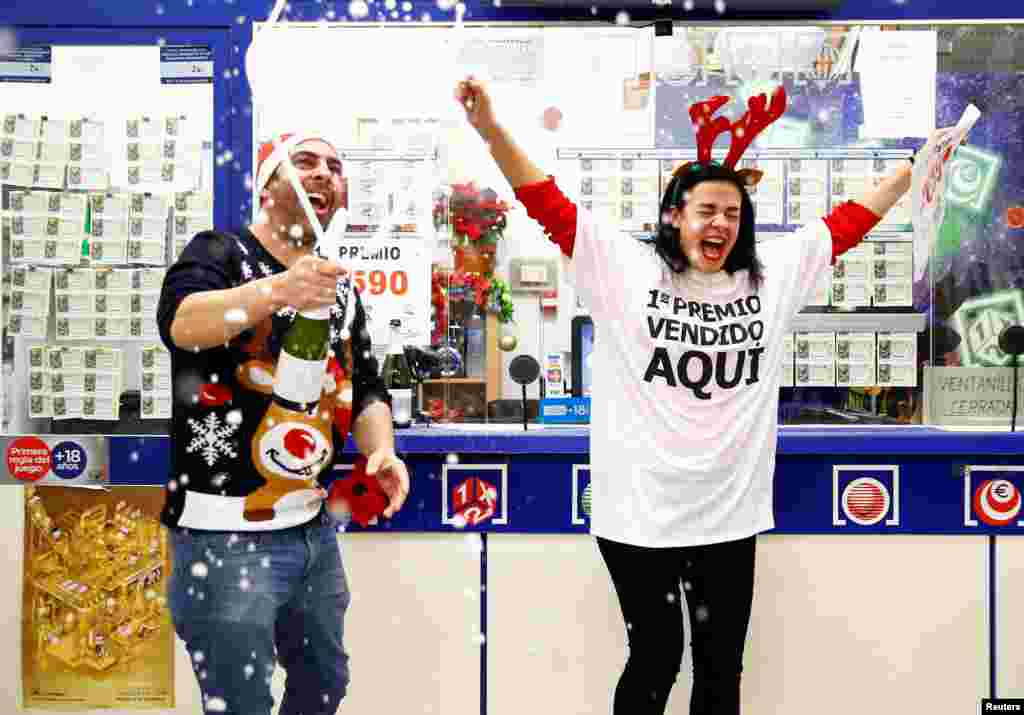 Owner Jose Maria Nogales and his wife Paloma Rodriguez celebrate selling the winning ticket of the biggest prize in Spain's Christmas lottery "El Gordo" (The Fat One) in Seville.