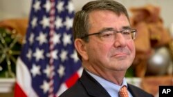 At the White House, Ashton Carter listens as U.S. President Barack Obama nominates him for defense secretary, Dec. 5, 2014. 