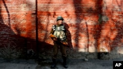 FILE - An Indian paramilitary soldier stands guard in Srinagar, Indian-controlled Kashmir, Jan. 25, 2015.