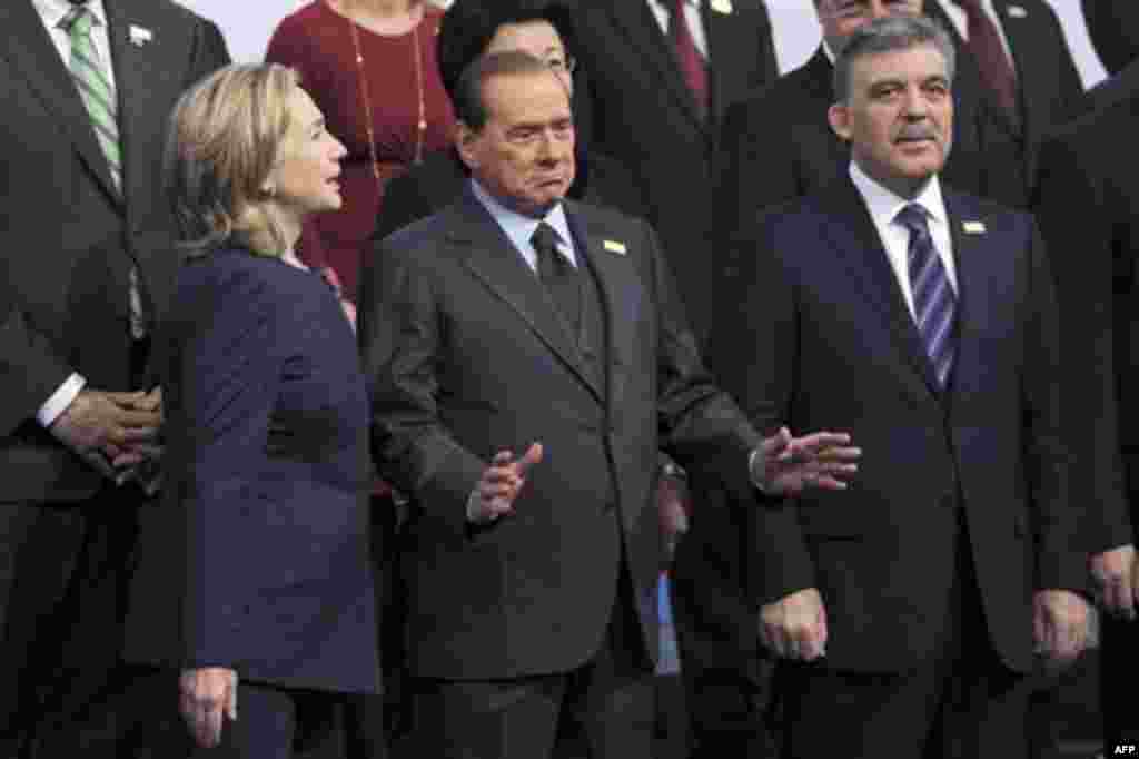 Italy's Prime Minister Silvio Berlusconi, center, gestures as he talks with U.S. Secretary of State Hillary Rodham Clinton, left , and Turkish President Abdullah Gul at the start of the OSCE Summit at the Palace of Independence in Astana, Kazakhstan, Wedn