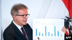 Austria's Health Minister Rudolf Anschober presents a diagram during a press conference on April 28, 2020 at the Chancellery in Vienna to comment on the country's actual situation amid the novel coronavirus Covid-19 pandemic. 