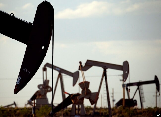 FILE - In this April 24, 2015, photo, pumpjacks work in a field near Lovington, N.M. Some studies show that the production of natural gas from the earth releases methane gas into the atmosphere. (AP Photo/Charlie Riedel, File)