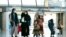 Families evacuated from Kabul, Afghanistan, walk through the terminal before boarding a bus after they arrived at Washington Dulles International Airport, in Chantilly, Virginia.