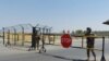 Uzbek soldiers guard a checkpoint near Friendship Bridge over the Amu Darya River, which separates Uzbekistan and Afghanistan, Termez, Uzbekistan, Aug. 15, 2021.