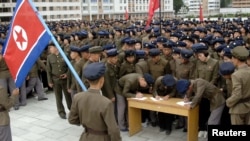 Young people sign petitions to join or return to the army this week, according to North Korean state media, at an undisclosed location in North Korea, in this undated photo released by North Korea's official Korean Central News Agency October 16, 2024. 