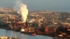 FILE - In this July 2, 2014 file photo, smoke billows out of a chiming chimney stack of BHP steel works at Port Kembla, south of Sydney, Australia. 