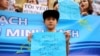 FILE - A Vietnamese boy holds a banner during a rally denouncing recent mass fish deaths in Vietnam's central province, in Hanoi, Vietnam, May 1, 2016. Tho show their solidarity, Taiwan-based Vietnamese workers took to the streets of Taipei on Monday.