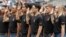 FILE - New Army recruits take part in a swearing in ceremony before a baseball game between the San Diego Padres and the Colorado Rockies in San Diego, June 4, 2017.