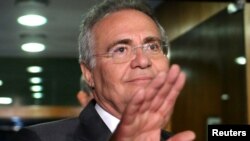 Brazil's Senate President Renan Calheiros waves to photographers in Brasilia, Brazil, Dec. 7, 2016. 