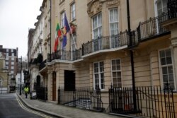 A street cleaner passes by the Myanmar embassy in the Mayfair district of central London, Feb. 1, 2021.