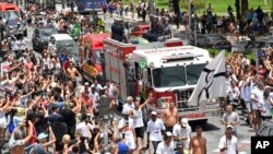 A fire truck brings the casket containing the body of Pele to the cemetery after his funeral in Santos, Brazil on Tuesday. (AP Photo/Matias Delacroix)