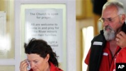 Red Cross volunteers leave a candlelight vigil following a second explosion at the Pike River Coal Mines in Greymouth, New Zealand, Nov. 24, 2010.