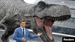 Cast member Chris Pratt poses in front of a model dinosaur while promoting the forthcoming film 'Jurassic World: Fallen Kingdom' in London, May 24, 2018. 