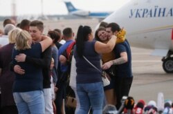 Relatives of Ukrainian prisoners freed by Russia greet them upon their arrival at Boryspil airport, outside Kyiv, Ukraine, Sept. 7, 2019.