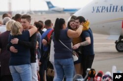 Relatives of Ukrainian prisoners freed by Russia greet them upon their arrival at Boryspil airport, outside Kyiv, Ukraine, Sept. 7, 2019.