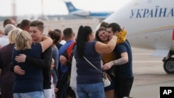 Relatives of Ukrainian prisoners freed by Russia greet them upon their arrival at Boryspil airport, outside Kyiv, Ukraine, Sept. 7, 2019. 