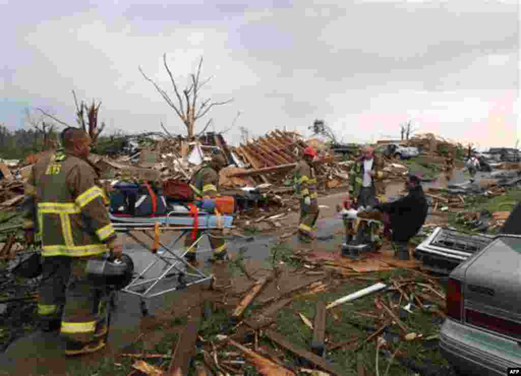 Birmingham Rescue attends to a man who was injured after a tornado hits Pratt City just north of downtown Birmingham on Wednesday, April 27, 2011, in Birmingham, Ala. The widespread destruction caused Gov. Robert Bentley to declare a state of emergency b