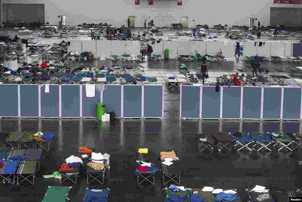 Migrants are seen in a makeshift bedroom for 2,200 refugees at the fair ground of Munich, Germany, Sept. 7, 2015.