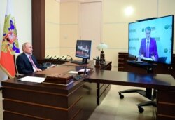 FILE - Russian President Vladimir Putin attends a meeting with Sberbank chairman German Gref via video conference at the Novo-Ogaryovo residence outside Moscow, Russia, June 9, 2020.