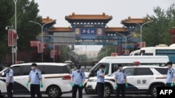 Chinese police guard the entrance to the closed Xinfadi market in Beijing on June 13, 2020. 