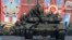 FILE - A Russian serviceman aboard a tank salutes during the Victory Day parade in Moscow's Red Square May 9, 2014.