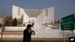 A Pakistani walks past the Supreme Court building in Islamabad, Feb. 10, 2021.