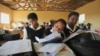 FILE - Children write notes from a makeshift blackboard at a school in Mwezeni village in South Africa's Eastern Cape Province, June 5, 2012. 