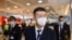 FILE - China Eastern Airlines flight crew wear protective masks on arrival at Sydney International Airport in Sydney, Australia, Jan. 23, 2020. (AAP Image/Joel Carrett/via Reuters) 