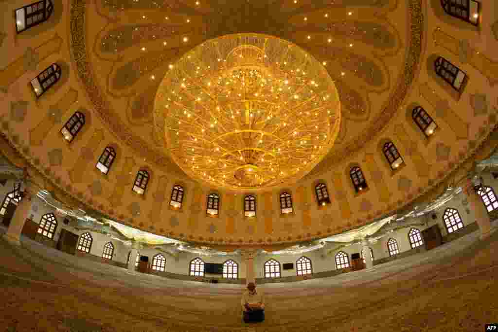 A man prays inside the closed Moussawi Grand Mosque in Basra, Iraq.