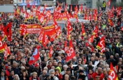 FILE - French Labor unions members attend a demonstration against French government's pensions reform plans in Marseille as part of a day of national strike and protests in France, Dec. 5, 2019.
