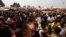 People displaced by the recent unrest, wait to collect food distributed by aid agencies at an IDP camp at the Mpoko International Airport of Bangui, Central African Republic, Feb. 12, 2014.