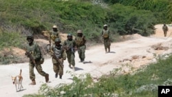 FILE - African Union soldiers, patrol in the Marka district 90 kilometers from the Somali capital, Mogadishu, July 17, 2016.