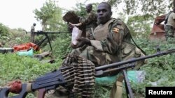 Ugandan soldiers serving with African Union Mission in Somalia take a break during patrols in Lafole village, near Afgoye district in Mogadishu, May 27, 2012. 