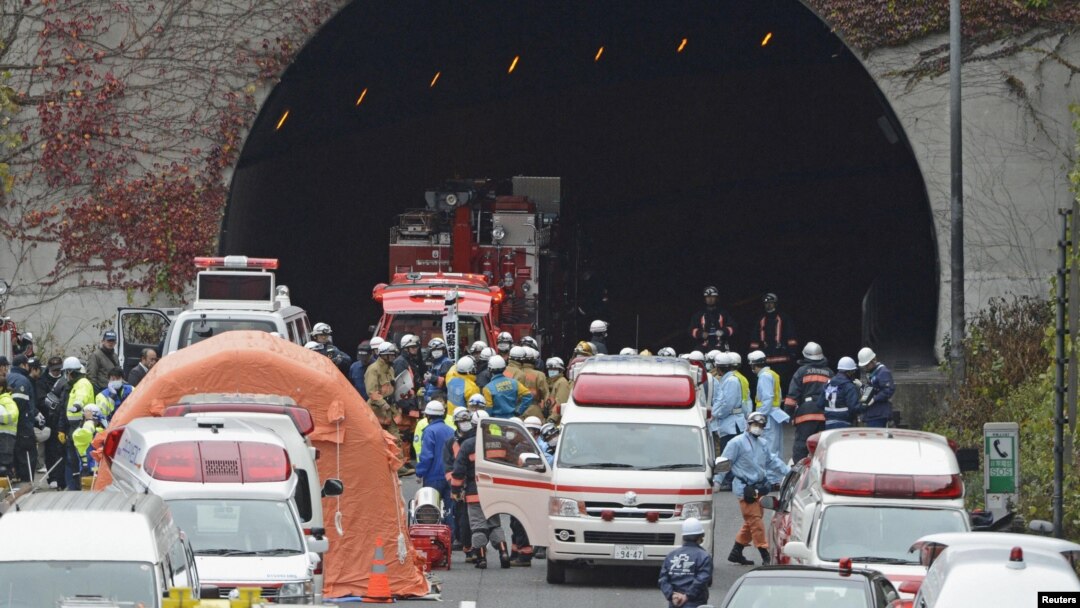Petugas pemadam kebakaran dan polisi berkumpul di deepen terowongan Sasago di Jalur Cepat Chuo di Otsuki, wilayah Yamanashi (2/12). Terowongan penghubung utama di pusat Jepang ini ambruk Minggu pagi, dan menewaskan sedikitnya tiga orang.