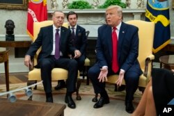 FILE - President Donald Trump meets with Turkish President Recep Tayyip Erdogan in the Oval Office of the White House, Nov. 13, 2019, in Washington.