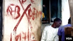 This building, like most in the settlement called Mpape, is marked for demolition with a red 'X,' in Abuja, Nigeria, August 2012. Residents say since the buildings were tagged, crime has gone up and many families already have moved out. (VOA - H. Murdock)