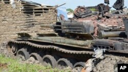 FILE - Tanks that have been destroyed during fighting between forces of Salva Kiir and Riek Machar, on July 10, 2016, in Jabel area of Juba, South Sudan.