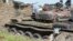 FILE - Tanks that have been destroyed during fighting between forces of Salva Kiir and Riek Machar, on July 10, 2016, in Jabel area of Juba, South Sudan.