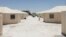 The undated photo released by U.S. Department of Health and Human Services shows detainees walk in a line at the HHS' unaccompanied alien children program facility at Tornillo, Texas. 