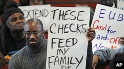 Frank Wallace who is unemployed displays a sign during a "Vigil for the Unemployed" at the Arch Street Methodist Church in Philadelphia, 22 Nov 2010