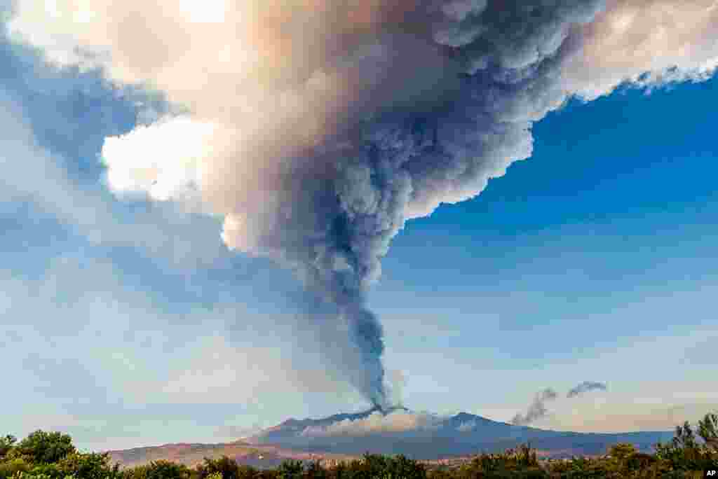 Smoke billows from the Mt. Etna volcano as seen from Giarre, Sicily.